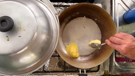 a woman roast cow butter organic healthy ghee in frying pan local people life cooking recipe in iran rural village scenic landscape top view of kitchen stove cooking food organic ingredient delicious