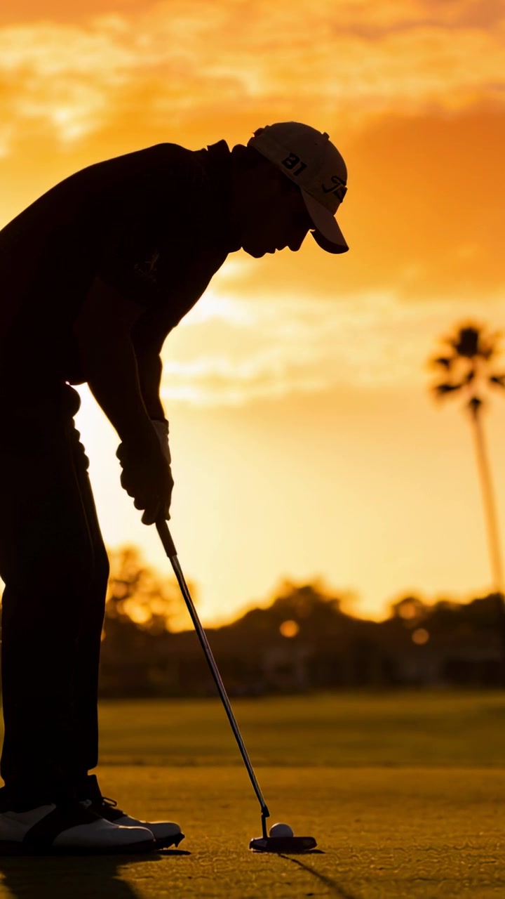 Video verticale: Giocatore di golf con cappellino che si prepara a colpire la palla con il putter, allineandosi sul green al tramonto e imbucando il putt.
