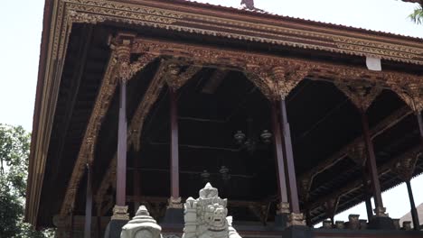 this is a roof and inside ubud palace, filming handheld, the camera tilted down