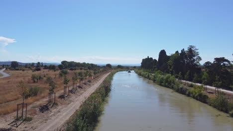 drone shot of a boat travelling on the canal du midi france