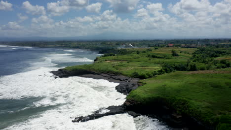 aerial drone footage, coastline with black rocks in bali