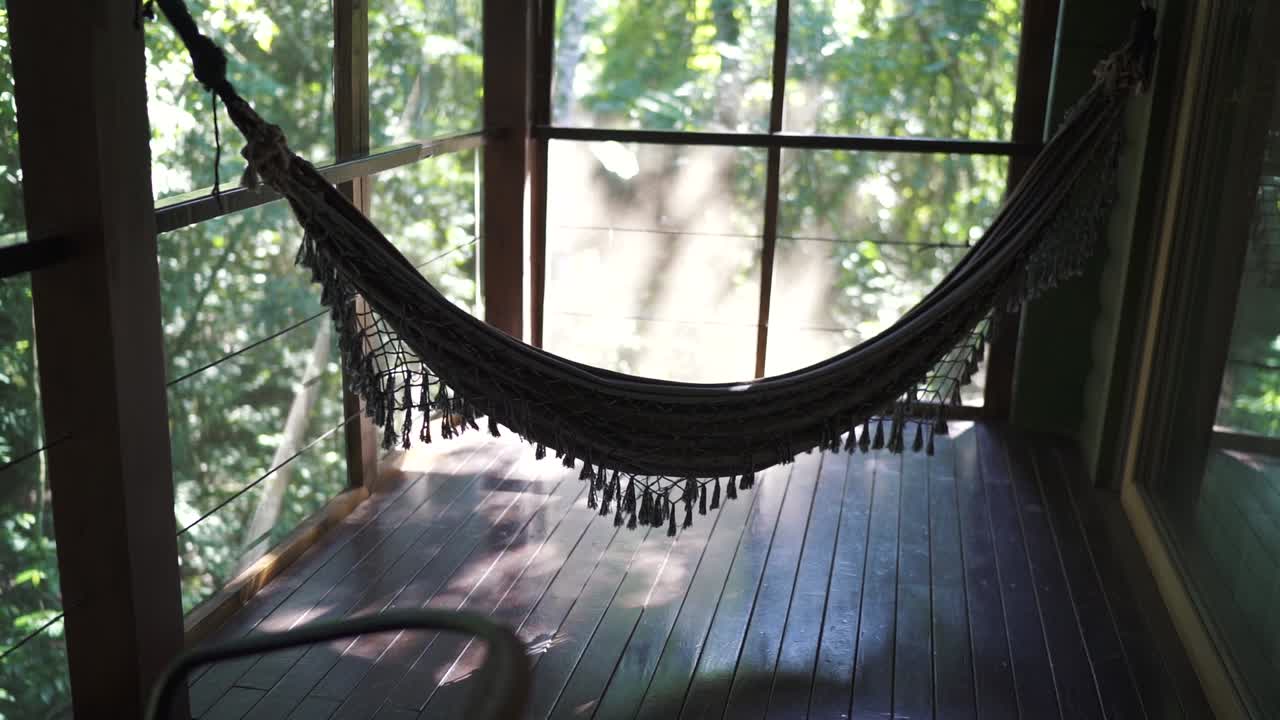 Relaxing Hammock on a Screened Porch Overlooking Lush Jungle