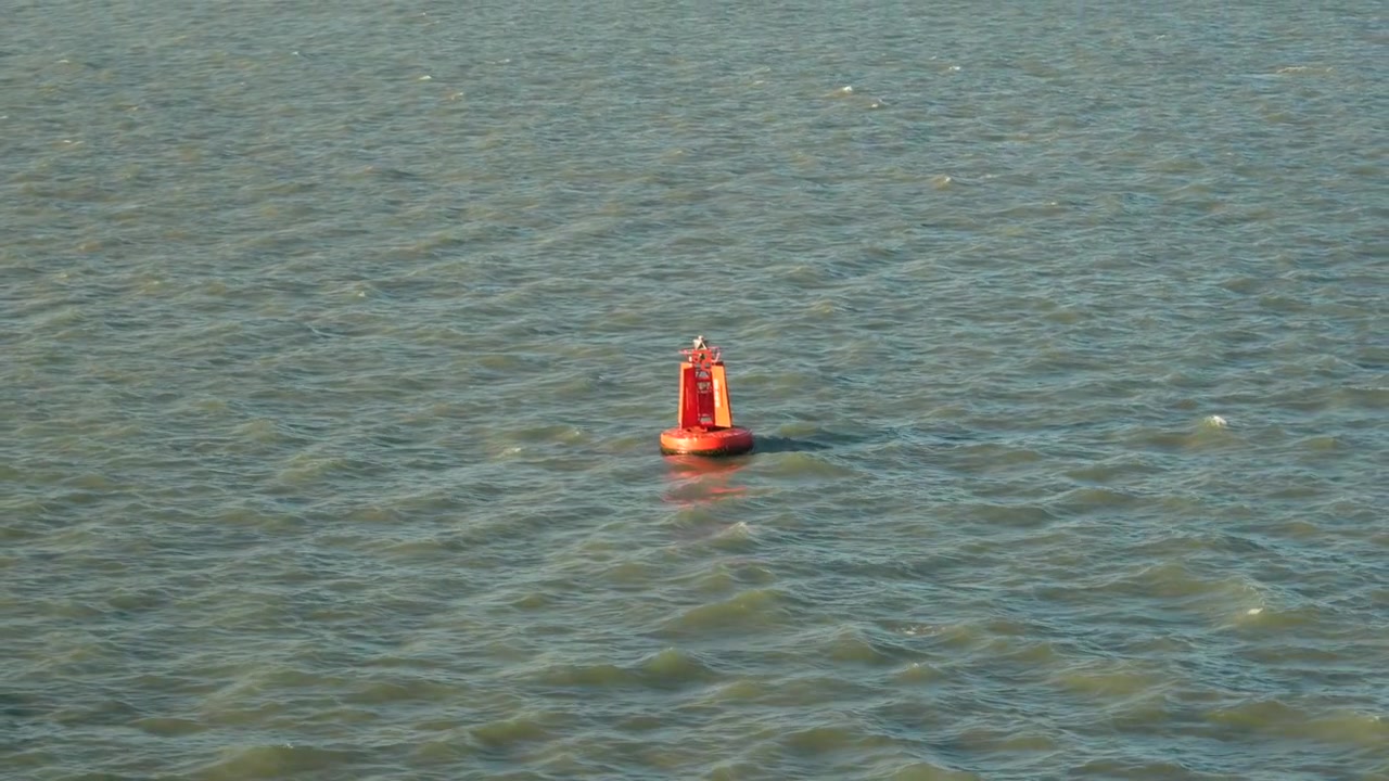 Red Port channel marker buoy. Coastal shipping channel navigation