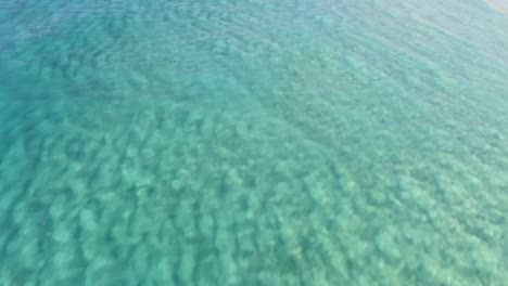 aerial footage of a perfectly crystal clear blue turquoise water in a tropical paradise