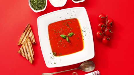 Tomato-soup-served-in-plate-with-spoon