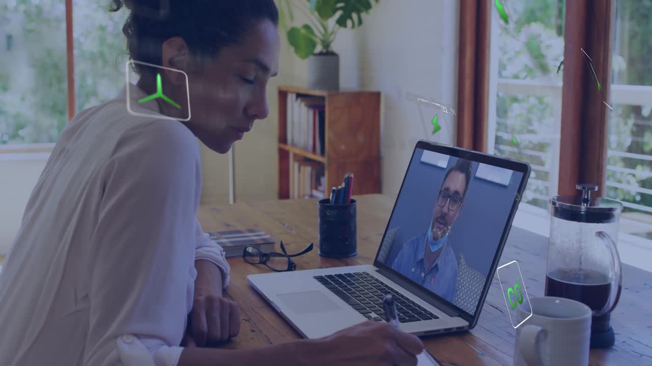 At business call start woman jotting notes for meeting as holographic icons floating around laptop