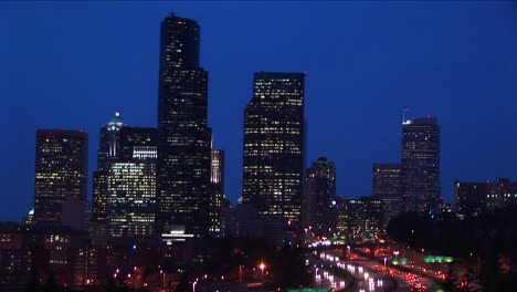 long shot of a group of seattle's skyscrapers towering above an innercity expressway