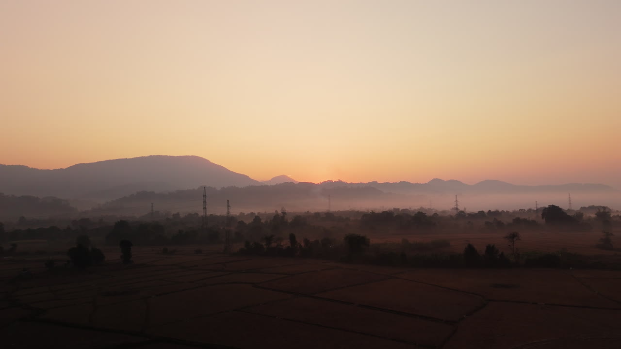 Sunrise over Misty Mountains and Rice Paddies