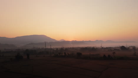 sunrise over misty mountains and rice paddies