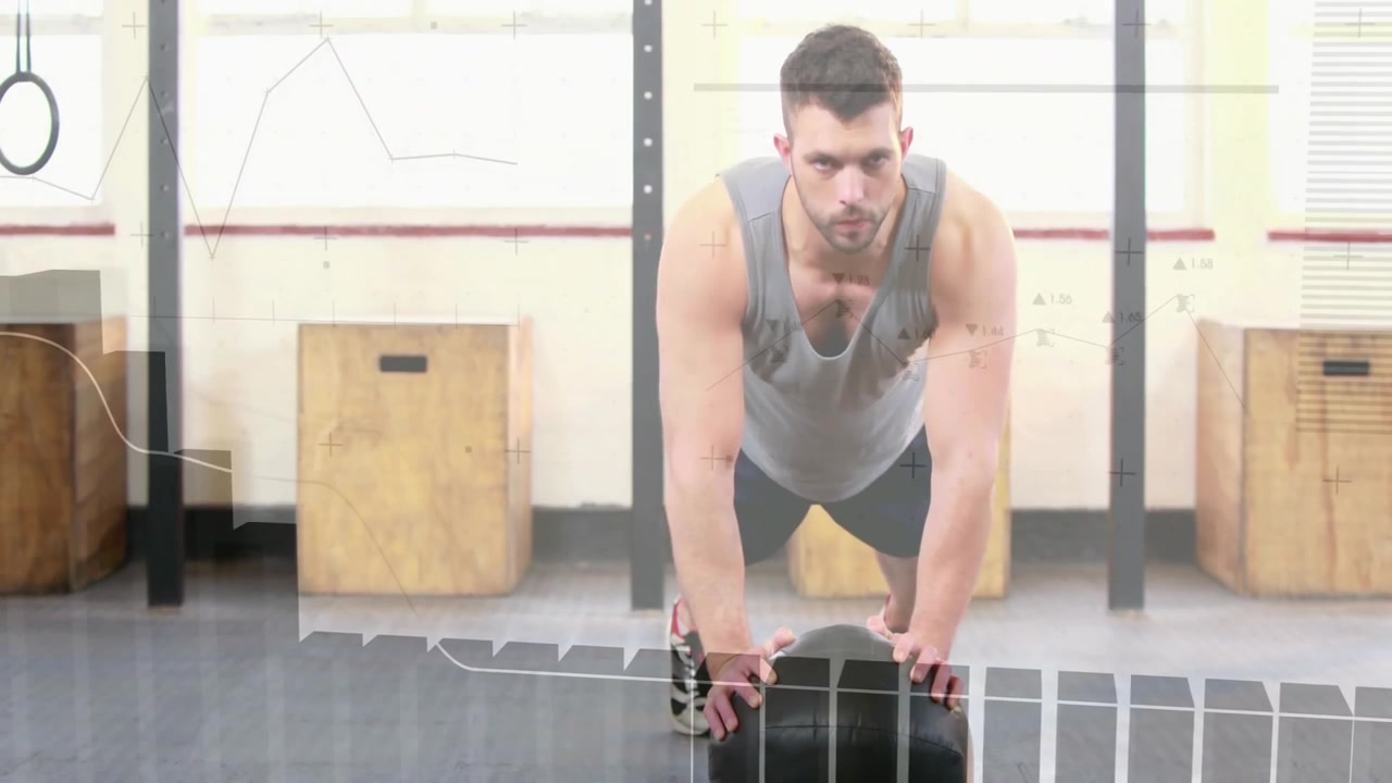 Fitness athlete gripping medicine ball planking lowering chest and pushing up for strength training