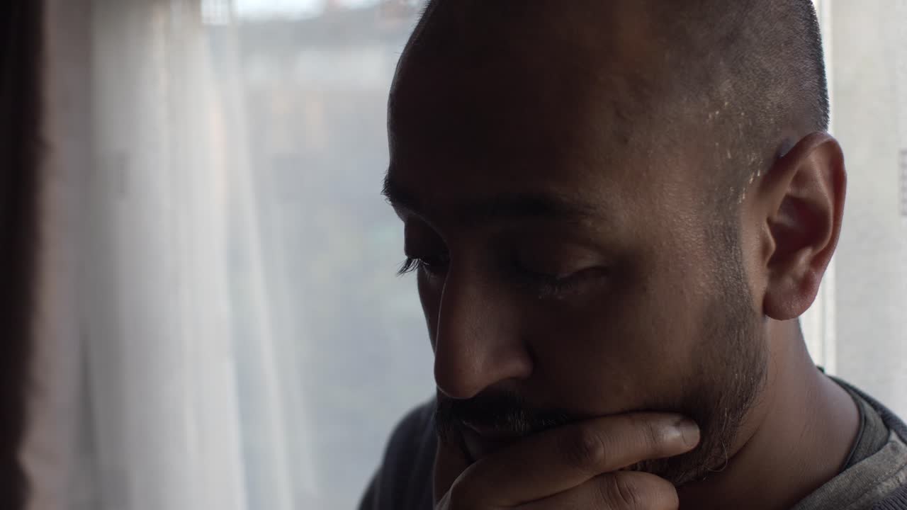 Stressed Adult Asian Male Massaging Face With Right Hand