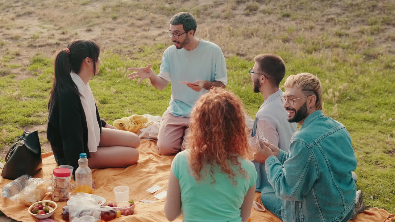 Friends Playing Cards at a Picnic