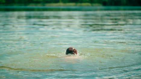 a kid in lake swimming and playing with water having fun