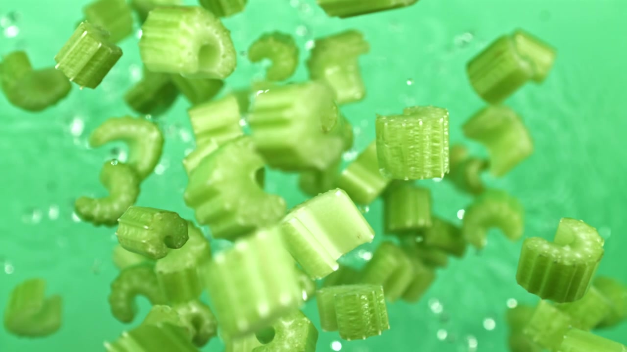 Fresh Chopped Celery Pieces Floating in Water in Slow Motion