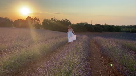 sun light shining on a cheerful woman relaxing in lavender fields