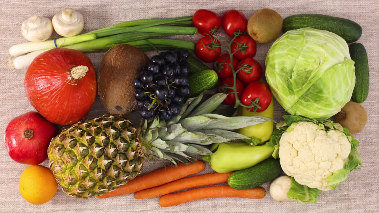 Fresh fruits and vegetables appear and filling the table. Stop motion