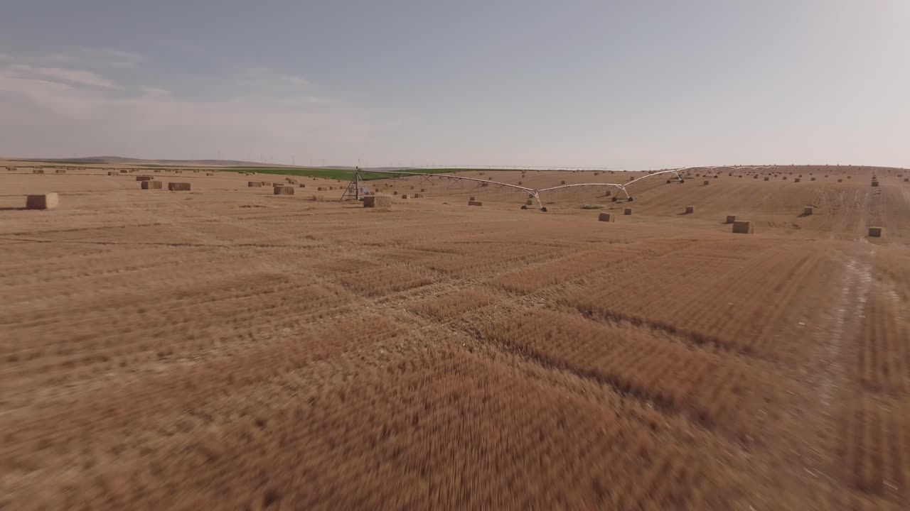 Hay Bales in a Field with Irrigation System