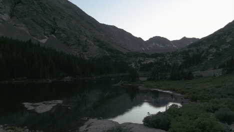 Breckenridge-iconic-Blue-Lake-near-Blue-River-wilderness-late-summer-afternoon-calming-sunset-aerial-pan-left