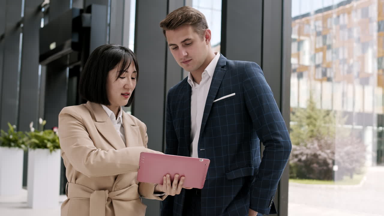 Two Business Colleagues Using Digital Tablet