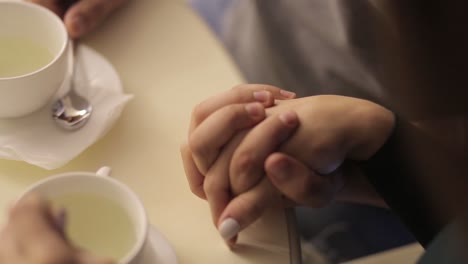 close-up of hands holding over tea