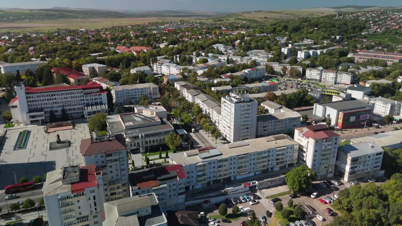 Aerial view of a vibrant city with greenery during a sunny day