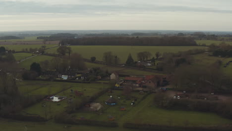 aerial drone shot flying over a farm house to reveal the vast landscape