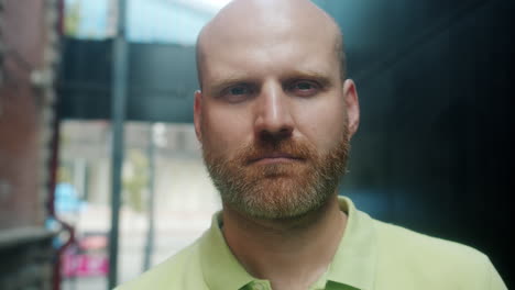 man with a beard in a light green polo shirt