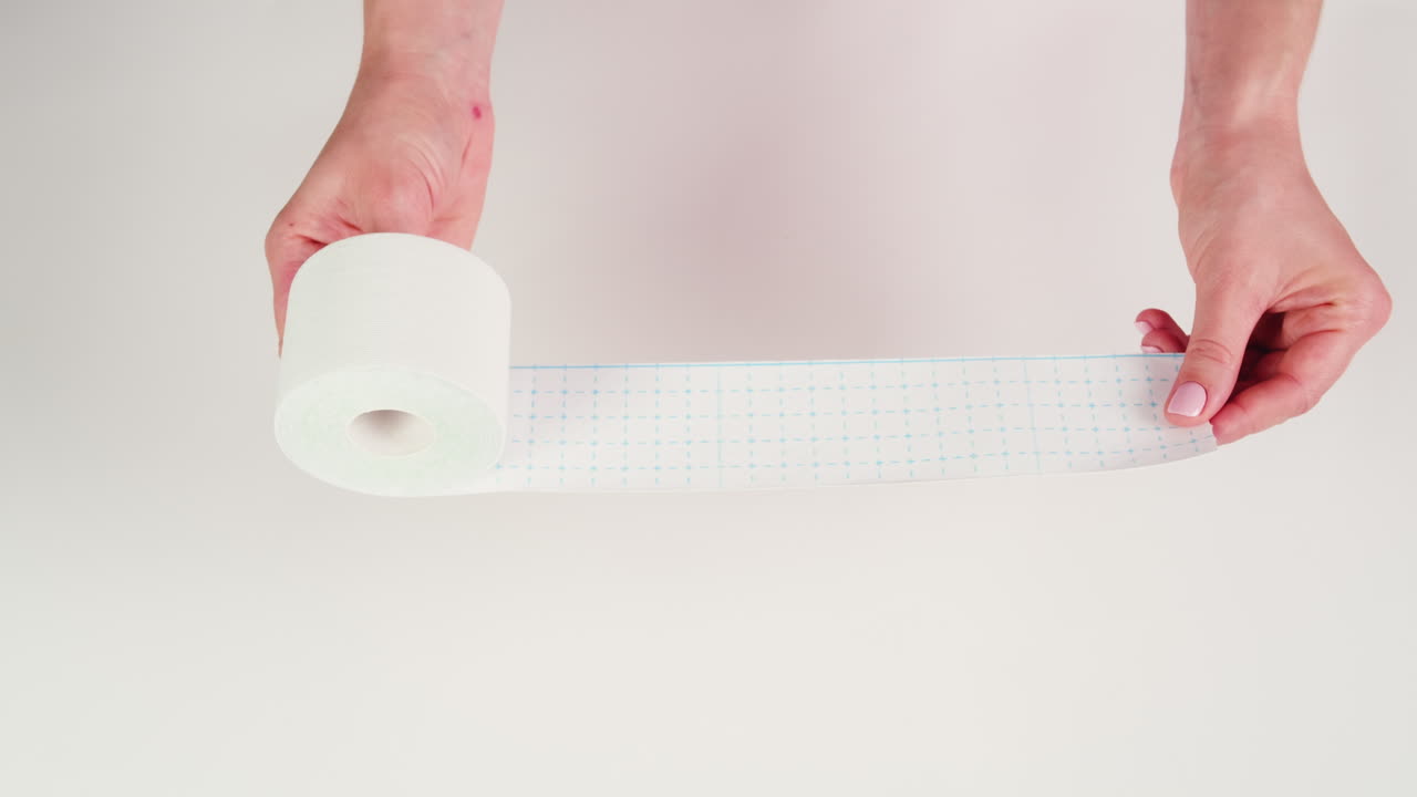 Kinesiology medical taping, doctor Physical therapist applying elastic surgical tape to patient body, treating injured knee young athlete.Post traumatic rehabilitation, sport physical therapy recovery