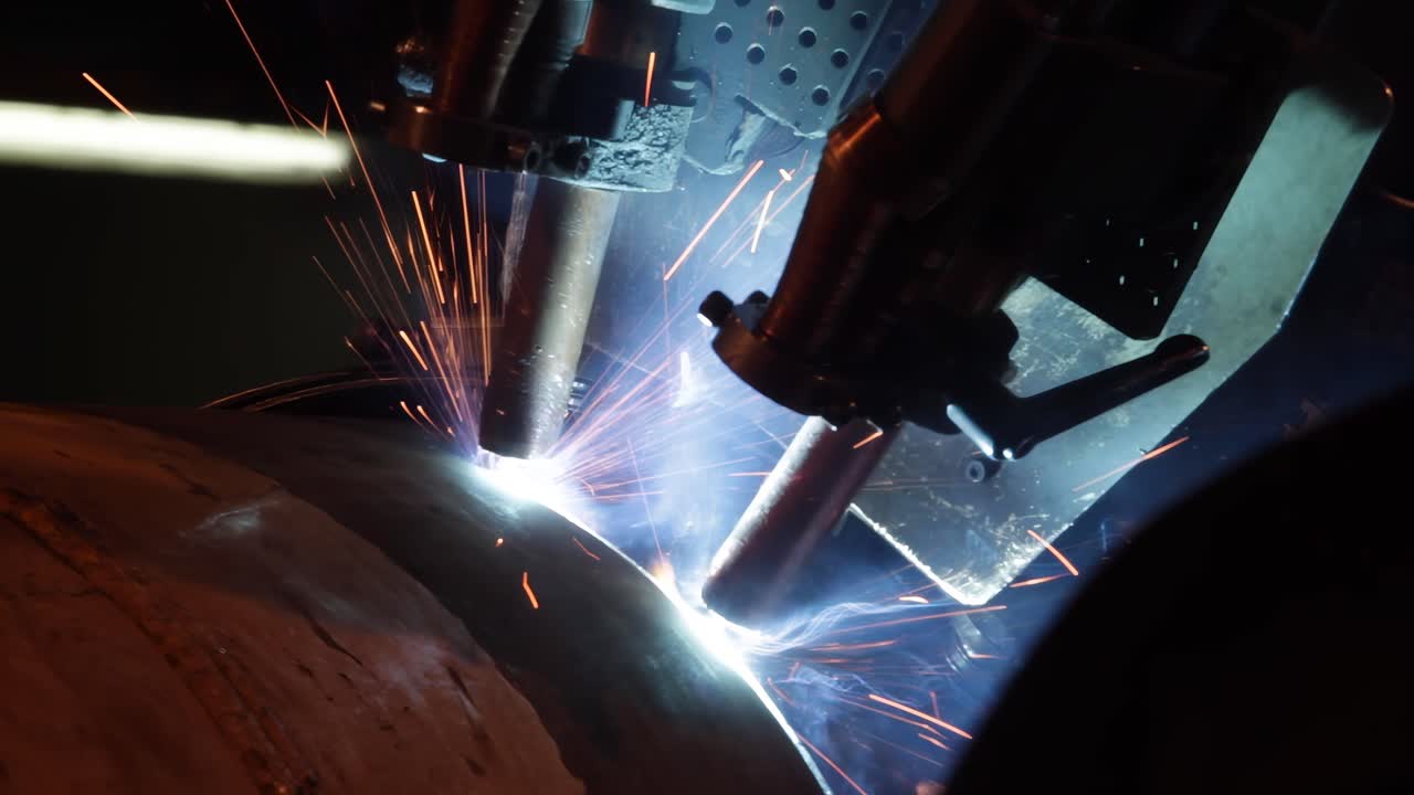 Industrial welding robot close up working on metal part Automated process with bright sparks Modern factory robotic arms welding steel Technology manufacturing industry video