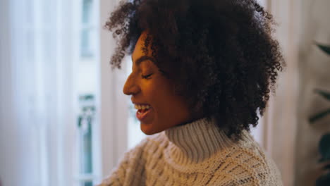 excited model waving at evening place closeup. african laughing woman greeting