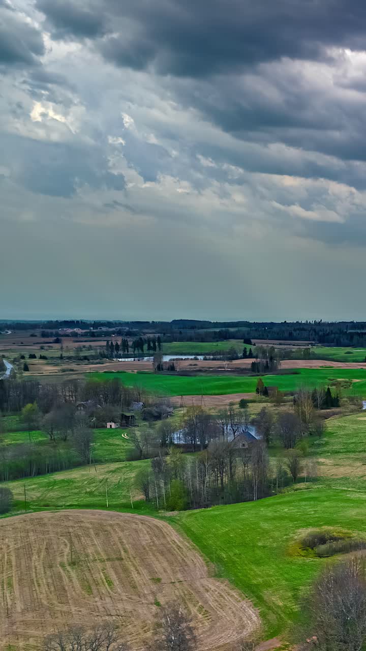 Rural village farmland land agriculture timelapse moving storm clouds vertical video