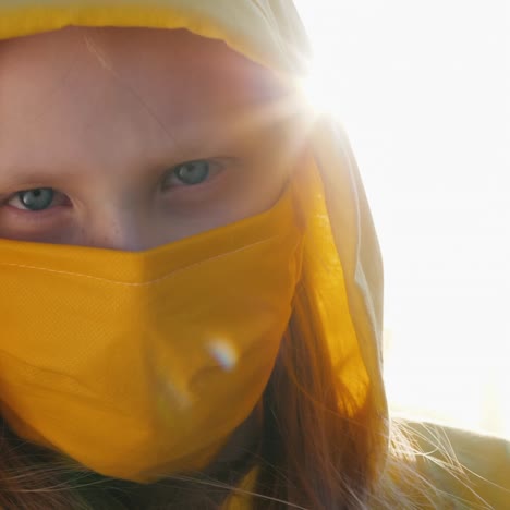 Portrait-Of-A-Girl-In-A-Yellow-Hood-And-A-Yellow-Protective-Mask-1