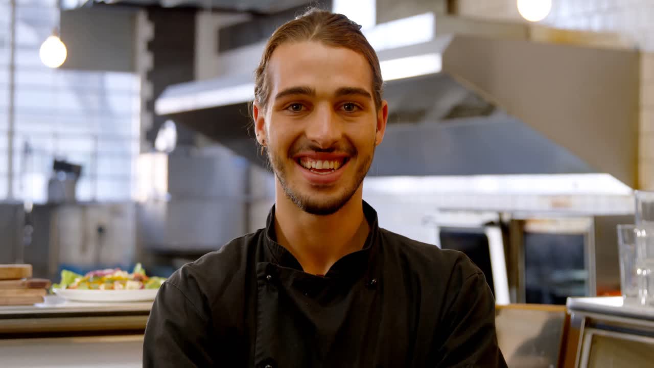 chef sonriente de pie con el brazo cruzado 4k