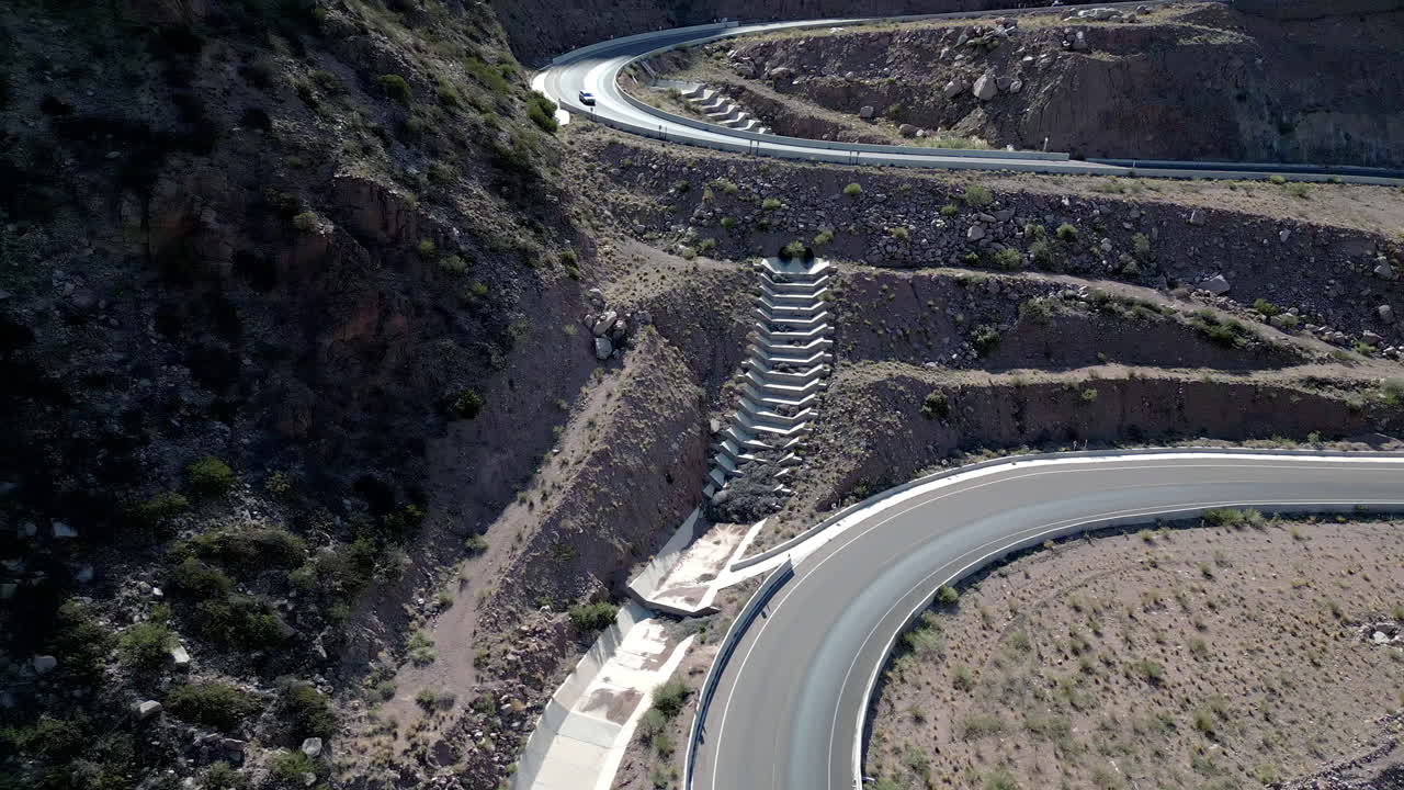 Aerial View of Winding Mountain Road in Arid Desert Landscape