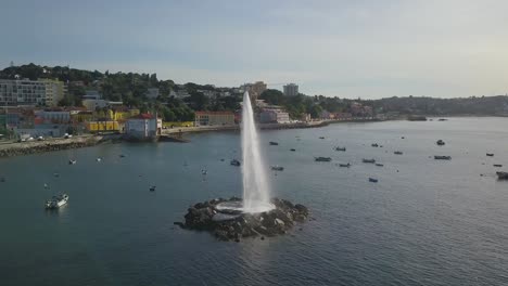 aerial drone view around the ocean fountain with oeiras in background, in paço de arcos, sunny day, in oeiras, lisbon