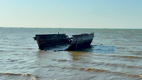 a broken boat rests on pattaya beach