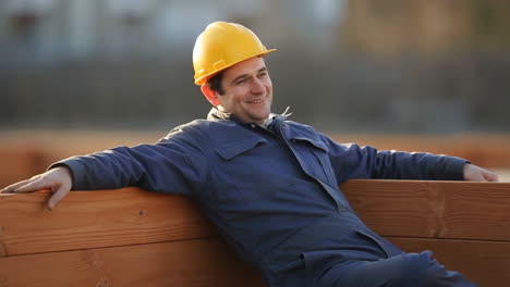 construction worker relaxing on a wooden bench