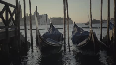 gondola swaying at the port in the morning light, venice