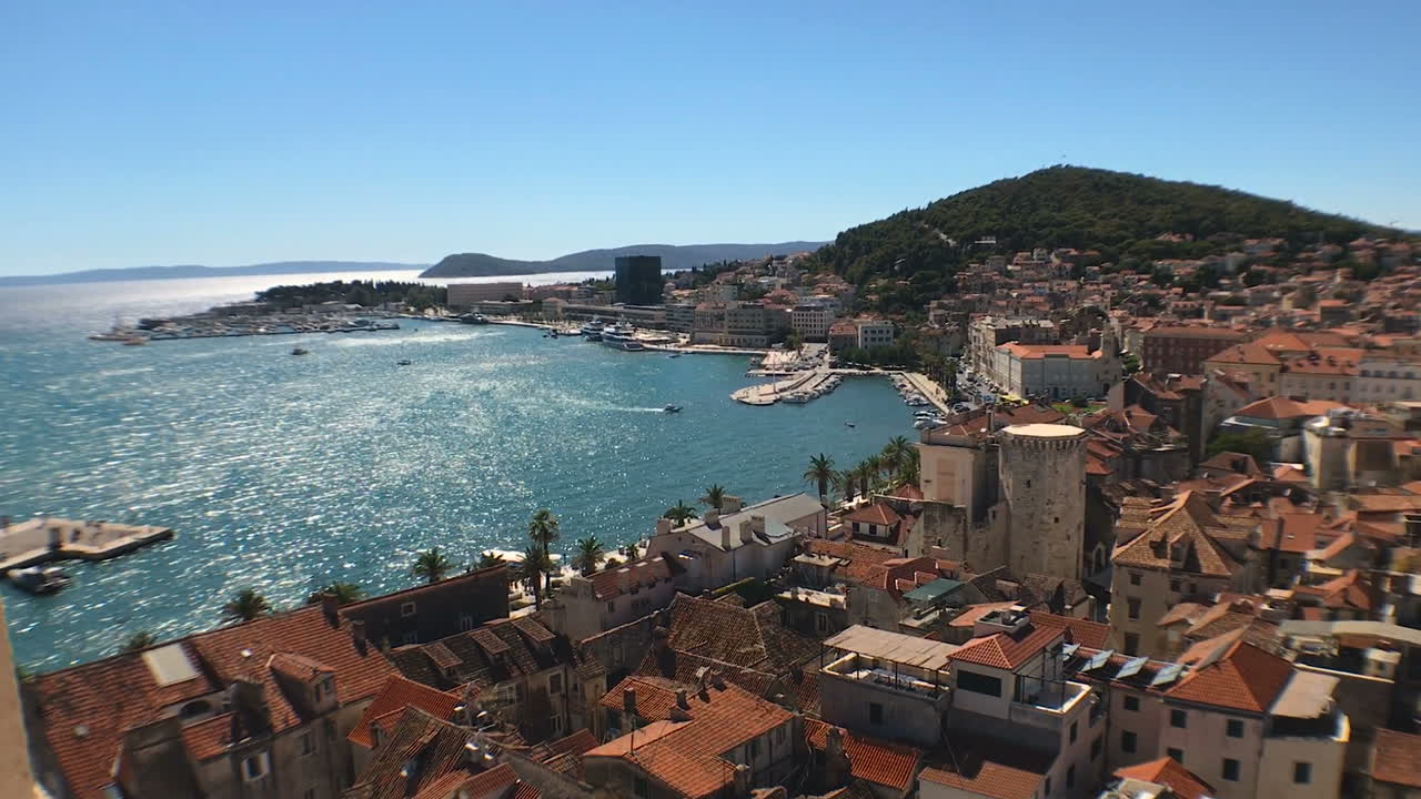Beautiful young woman enjoying the view of old Split town from Duje cathedral on sunny summer day