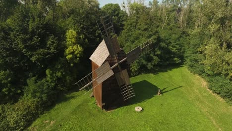 historic, renovated mill in a polish open-air museum surrounded by greenery during the summer in poland