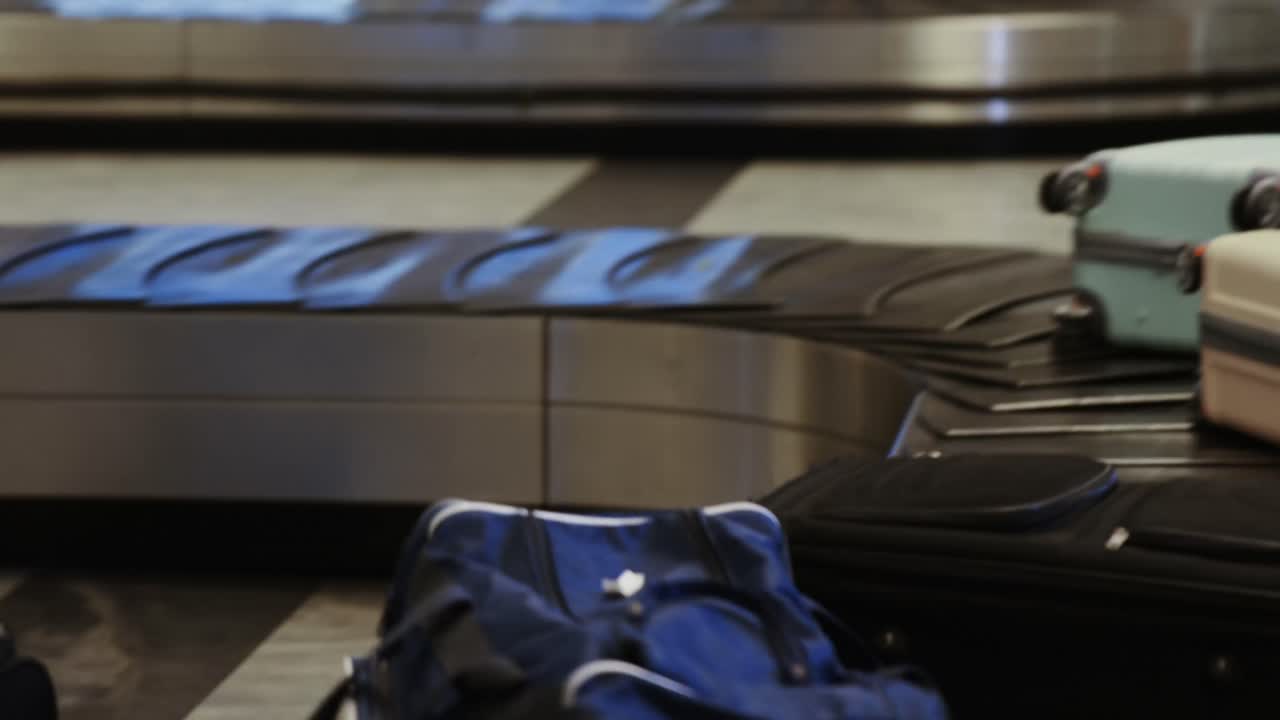 Businessman taking his luggage off the baggage carousel
