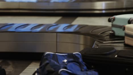 businessman taking his luggage off the baggage carousel