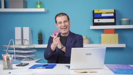 Businessman-clapping-while-looking-at-camera-with-pride-and-joy.