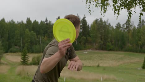 disc golfer warming up - medium shot behind