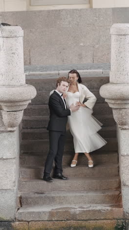 couple in elegant outfits on steps