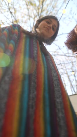 two girls wearing colorful ponchos