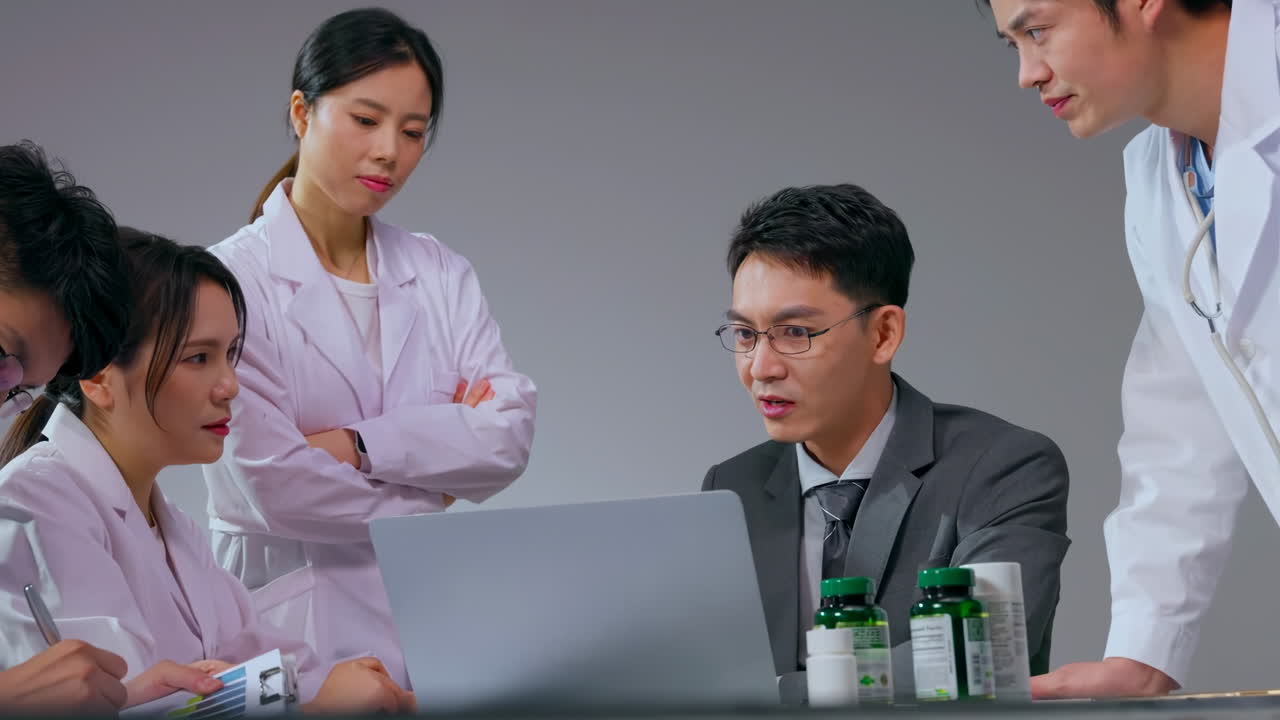 Real shot professional Male pharmaceutical representative showing prescription medication to doctor in hospital