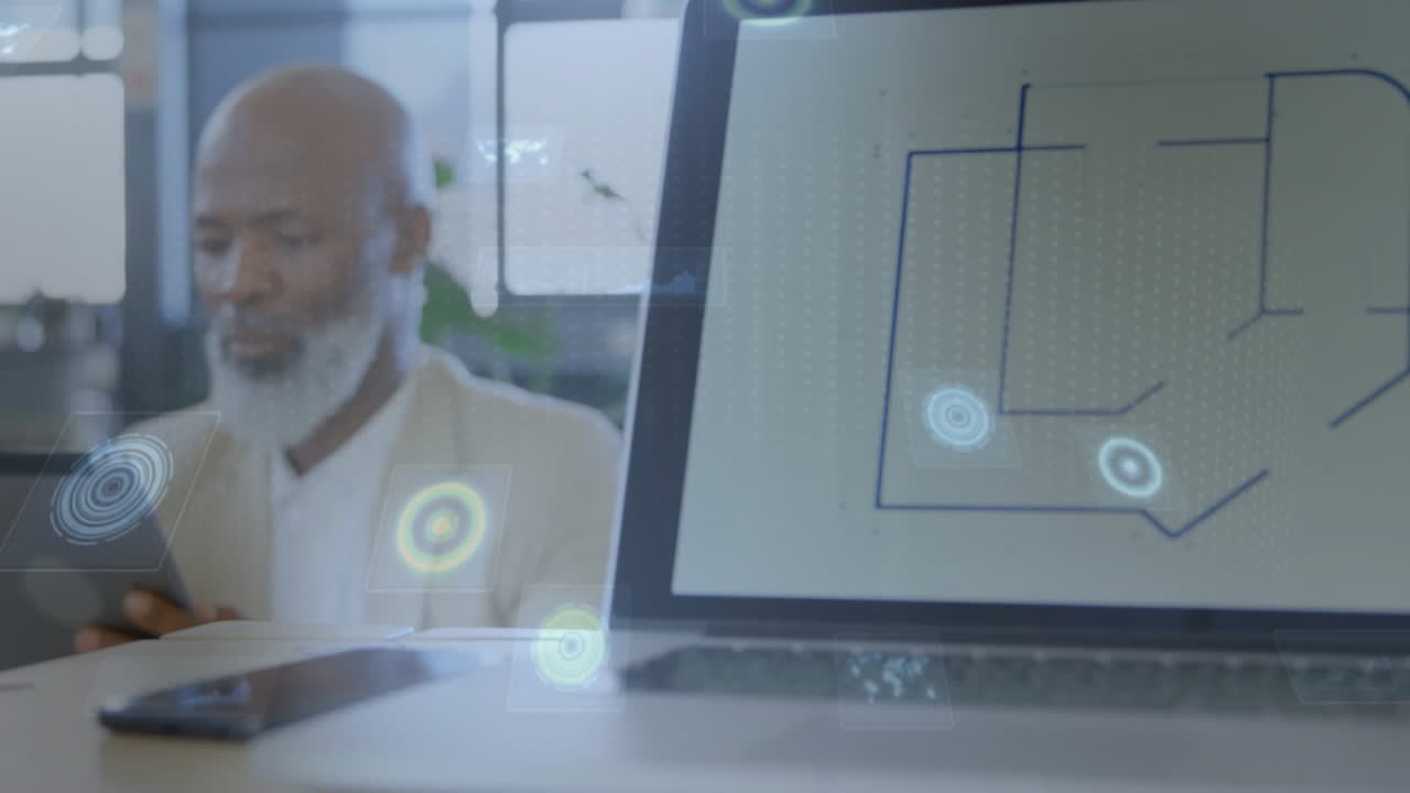 Elderly man working at desk with digital network animation over laptop screen