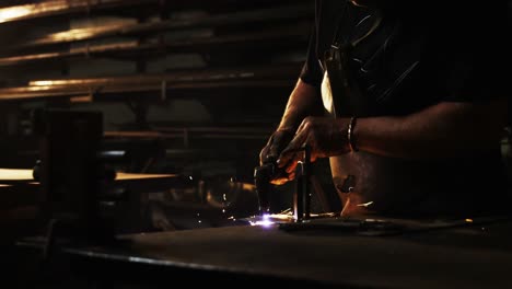 welder using welding torch