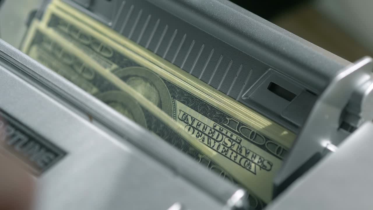 Machine counter automatic calculates a large amount of Dollar banknotes in 4K Slow motion 60fps